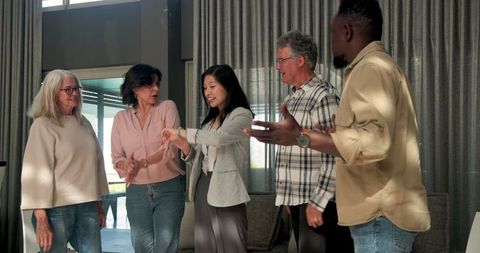 Therapist bidding farewell to diverse group at mental health session