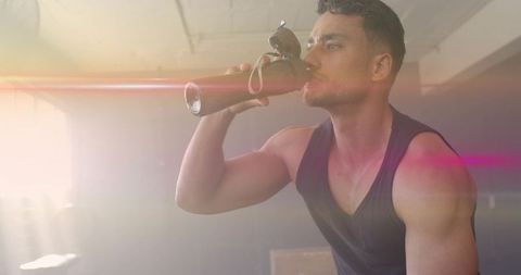 Fit Man in Gym Drinking Water from Stainless Steel Bottle with Sunglasses