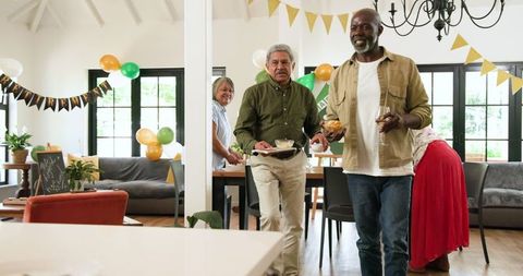 Senior Friends at Retirement Party Cleaning Up Together