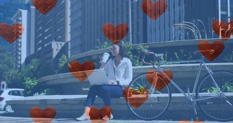 Young Woman Enjoying City Life with Laptop and Coffee