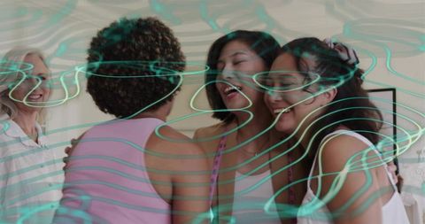 Women hugging in bright living room with turquoise overlay celebrating friendship