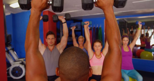 Fitness Instructor Leading Group Strength Training with Dumbbells - Download Free Stock Images Pikwizard.com