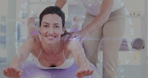 Mid Adult Completing Physical Therapy with Trainer Guidance