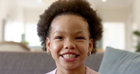 Joyful Young Girl in Relaxed Home Setting Smiling Brightly