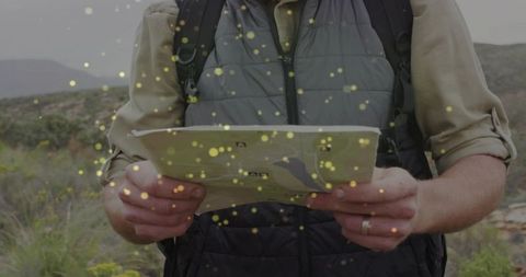 Hiker Holding a Map Amidst Wilderness Exploration Adventure