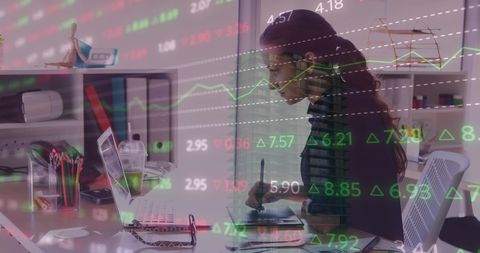 Businesswoman Analyzing Financial Data with Laptop and Graphs