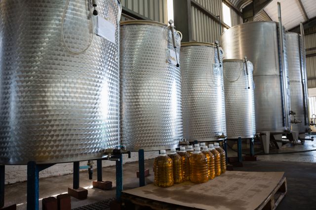 olives oil bottle kept next to drum in factory