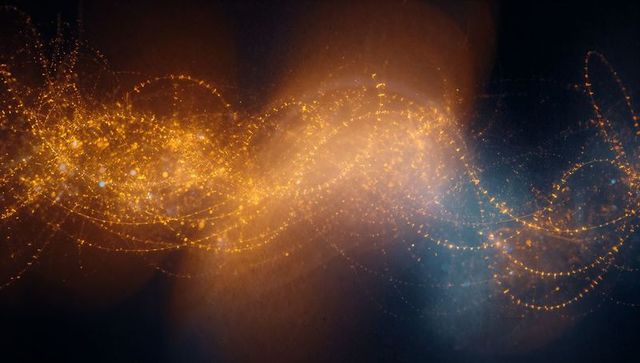 Glowing golden light ribbon curving through dark space with sparkling bokeh trails