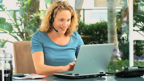 Curly-Haired Businesswoman Engaging in a Virtual Meeting