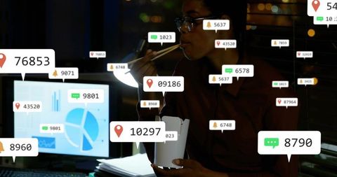 Focused Professional Eating Takeout While Monitoring Data at Night