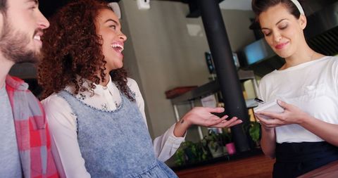 Happy Diners with Waitress in Casual Restaurant