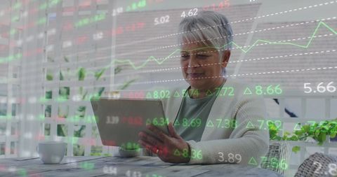 Senior Woman Analyzing Digital Finance Data on Tablet