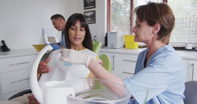 Dental Hygienist Discussing Treatment Plan with Patient in Dental Office - Download Free Stock Images Pikwizard.com