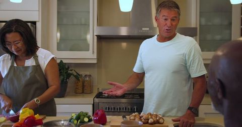 Group cooking and socializing in modern kitchen