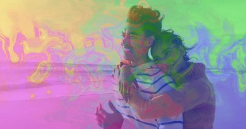 Romantic couple hugging by beach with pastel sky