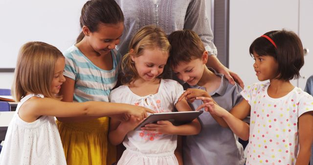 Young Children Collaborating on Tablet in Classroom Setting - Download Free Stock Images Pikwizard.com