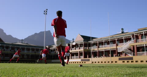 Rugby Player Practicing Kick on Sunny Field