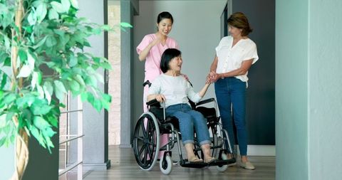 Senior Woman in Wheelchair with Diverse Companions in Conversation