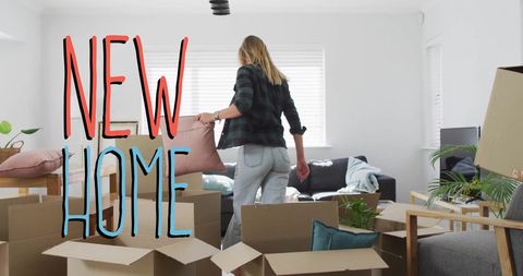 Woman unpacking boxes in moving new home