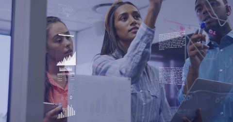 Team Collaborating on Digital Data at Glass Whiteboard