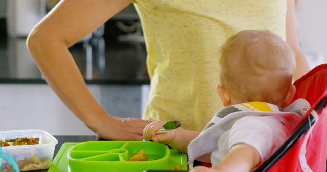 Parent and Baby Interacting During Mealtime in Kitchen - Download Free Stock Images Pikwizard.com