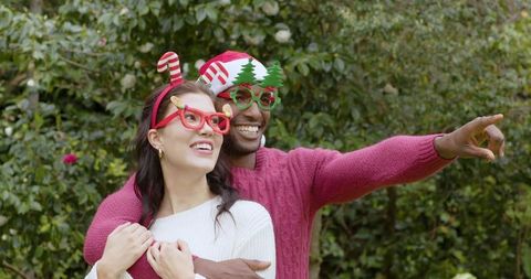 Couple in Yard Celebrating with Fun Holiday Accessories