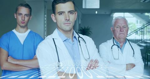 Medical team standing with arms crossed and digital data overlay in hospital corridor