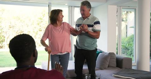 Senior Couple Enjoying Supportive Interaction at Home with Healthcare Professional
