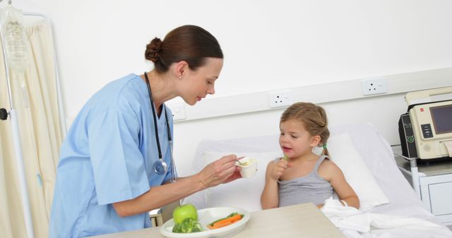 Doctor Feeding Young Patient in Hospital Room - Download Free Stock Images Pikwizard.com
