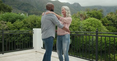 Couple Enjoying Serene Mountain View from Balcony Embracing Nature