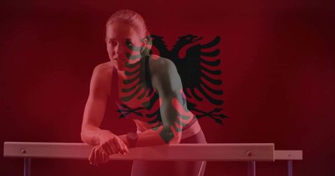 Female Athlete Leaning on Training Bar with Albanian Eagle Overlay, Red Dramatic Lighting