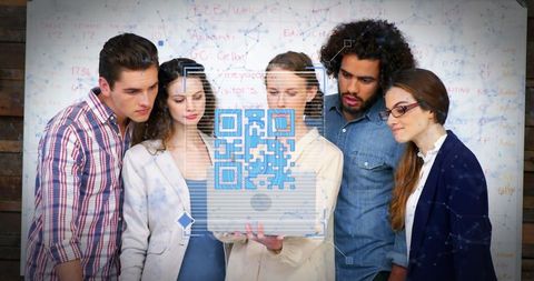 Team analyzing qr code technology for innovative office project