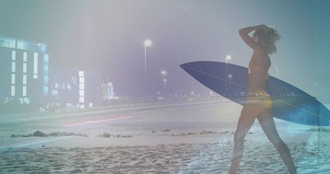 Walking female surfer on night beach with surfboard and urban light trails