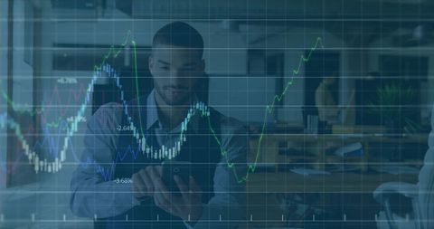 Bearded professional tapping tablet while augmented finance charts overlay open office