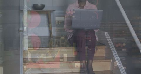 African american woman utilizing technology indoors with digital overlay