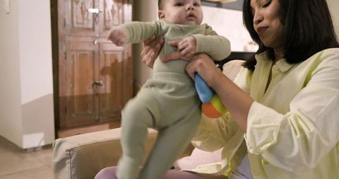 Mother and Infant Bonding While Sitting on Couch at Home