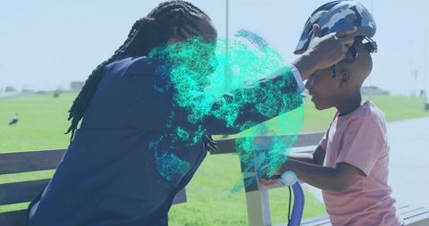 Guardian placing helmet on child scooter rider with holographic globe overlay in park