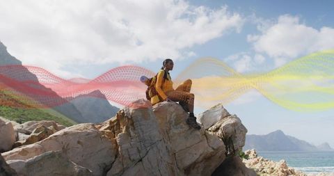 Solo Hiker on Cliff Gazing Over Serene Ocean