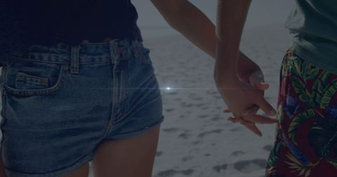 Beach Romance: Couple Holding Hands in Sunlight