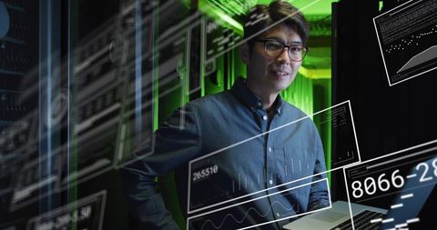 Data center engineer monitoring network performance with laptop, digital overlays and hud