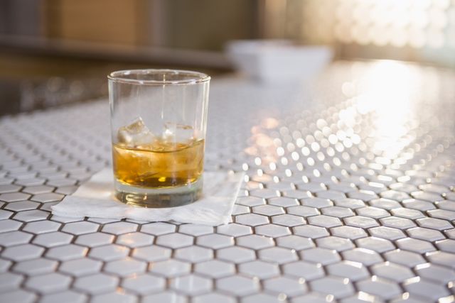 Glass of whisky on bar counter in bar
