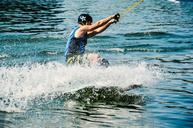 Man Wakeboarding on Water, Creating Splash - Download Free Stock Photos Pikwizard.com