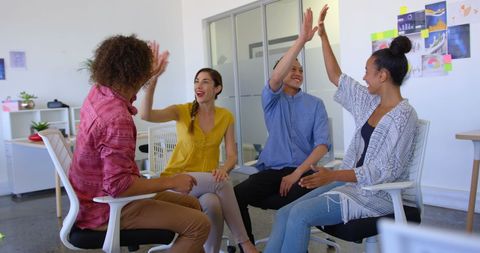 Diverse Team Collaborating with High Fives in Modern Office Environment - Download Free Stock Images Pikwizard.com