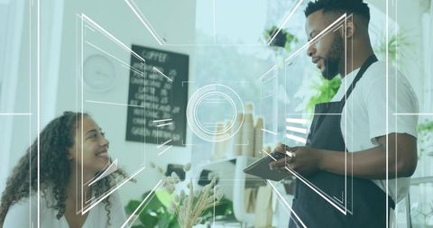 Barista Taking Customer Order at Cozy Urban Cafe with Tablet