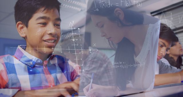 Image of mathematical equations over schoolboy using laptop in classroom. education, learning and technology concept digitally generated image.