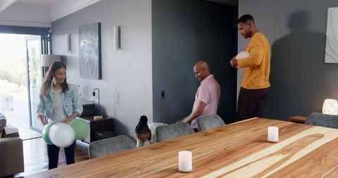 Friends Preparing for Celebration with Balloons in Living Room
