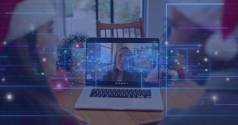 Multigenerational Family Connecting on Virtual Holiday Call with Laptop and Festive Decor