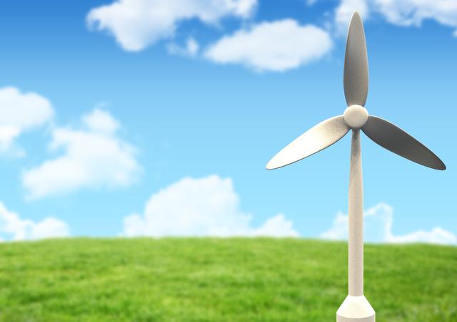 This image features a close-up of a windmill with green grass and a blue sky in the background. It is ideal for illustrating concepts related to renewable energy, sustainability, and eco-friendly practices. It can be used in environmental campaigns, educational materials, and articles about clean energy and wind power.