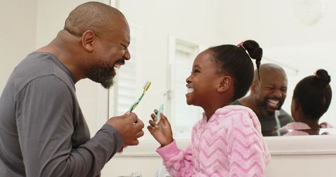 Father Daughter Brushing Teeth Sharing Joyful Moment