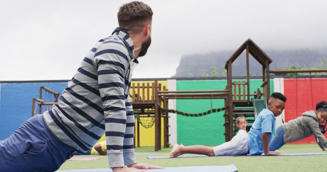 Teacher Leading Outdoor Yoga Session with Children - Download Free Stock Images Pikwizard.com